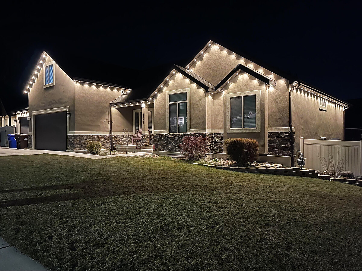 Soft white permanent lighting along multiple roof gables
